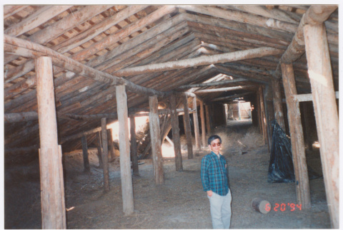 Photo of Kenji Ima in a barn (ddr-densho-483-14)