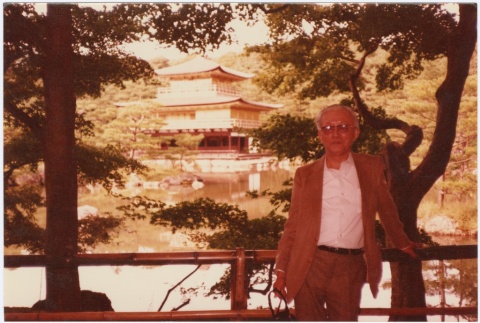 Larry Tajiri in front of a Japanese temple (ddr-densho-338-44)