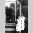 Owners standing in front of grocery store (ddr-densho-136-27)