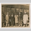 Six men posing in front of a train (ddr-densho-223-7)