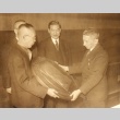 Four men looking at a plaque (ddr-njpa-4-132)