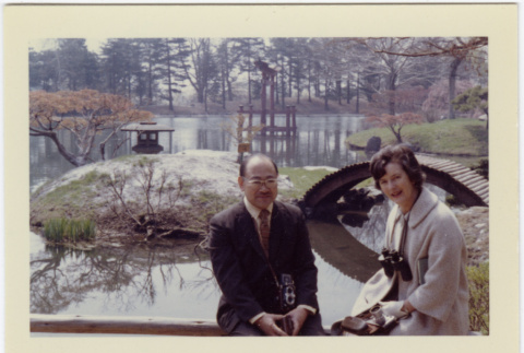 Kaneji Domoto with Elaine Reinelt sitting in Japanese Garden (ddr-densho-377-1348)