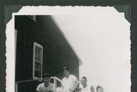 Seven men on steps outside barrack (ddr-densho-471-103)