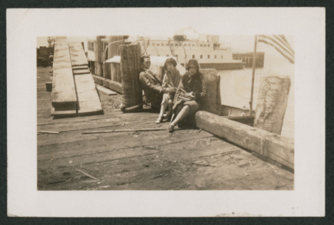 two women and a man sitting on dock (ddr-densho-378-773)