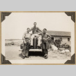 Roy Sumida and two others on a car (ddr-densho-542-458)