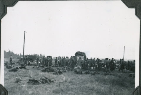 Men in field with gear and loading trucks (ddr-ajah-2-241)