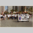 Veterans carrying banner in parade (ddr-densho-466-510)