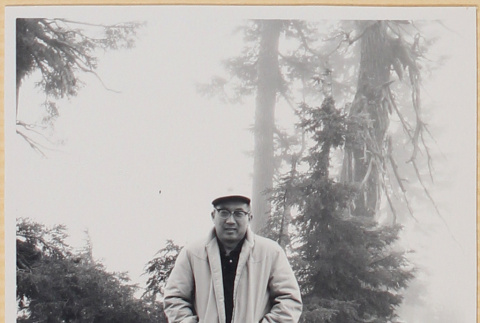 Man standing by stone wall (ddr-densho-522-119)