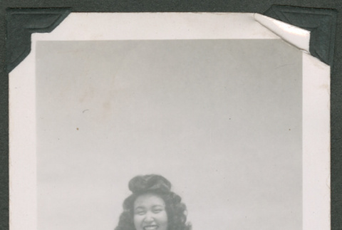 Woman smiling outside a barrack (ddr-densho-463-22)