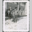 Two men, arm-in-arm, outside building with group in background (ddr-densho-434-485)