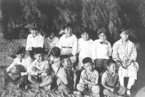 Children sitting under a pepper tree (ddr-densho-107-18)
