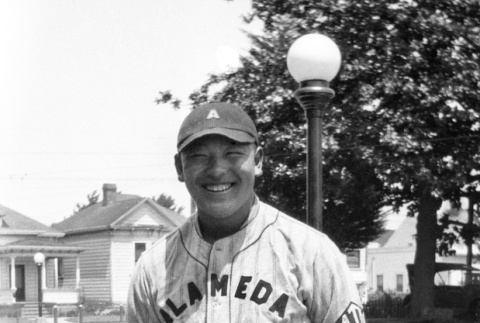 Man in baseball uniform standing in garden (ddr-ajah-5-66)