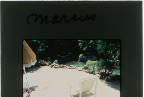 Pool and lounge chairs at the Marcus project (ddr-densho-377-469)