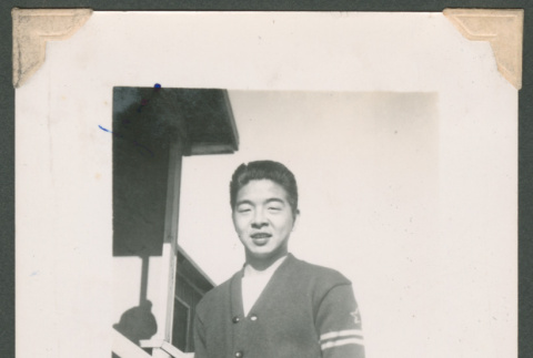 Shoji Ichikawa in a letterman sweater (ddr-densho-463-65)