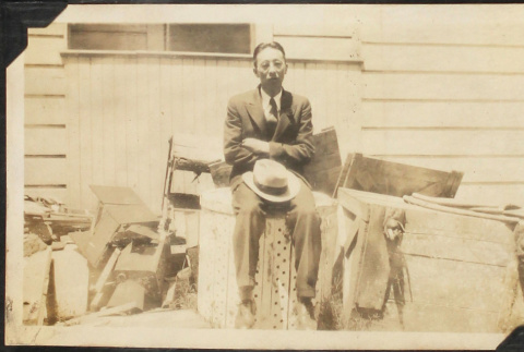 Man sitting on crates (ddr-densho-423-520)