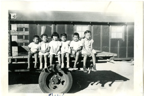 Six children sitting on a truck bed (ddr-manz-6-52)