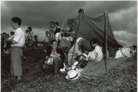 Japanese refugees making camp in a field (ddr-densho-299-113)
