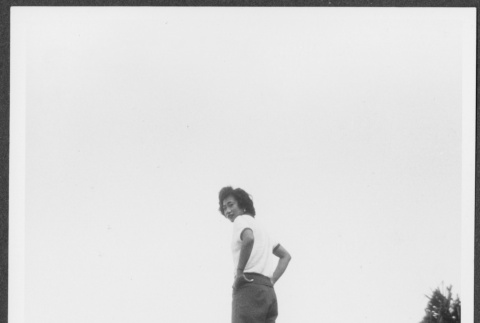 Nisei woman poses on wall (ddr-densho-363-168)