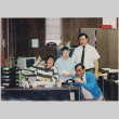Four people around a desk (ddr-densho-426-1201)