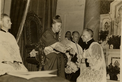 James Sweeney seated on cathedra and priests in vestments (ddr-njpa-2-939)
