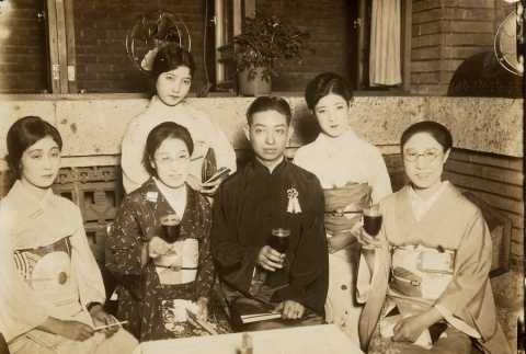 Women in kimono gathered around a table with a man (ddr-njpa-1-4)