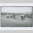 Hart (sic) Mountain Relocation Camp, People with luggage walking through camp (ddr-densho-122-745)