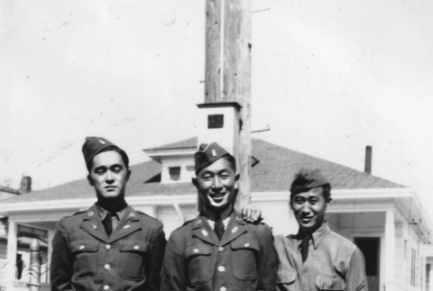 Three men standing outside building (ddr-ajah-2-768)