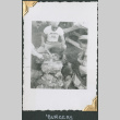 Man in Camp Grant t-shirt cooking hamburgers (ddr-densho-434-214)