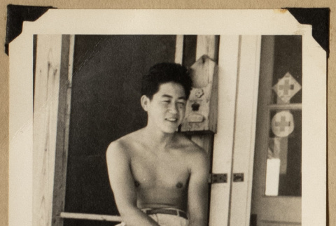 Hiro on a porch (ddr-densho-542-542)