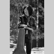 Mike Okagaki standing with a guitar case (ddr-densho-336-633)