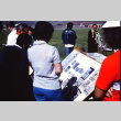 Pilgrims looking at a photograph display at the former site of Tule Lake (ddr-densho-294-31)