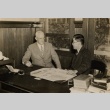 Lester Petrie and another man seated behind a desk (ddr-njpa-2-808)