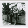 Tomoye (Nozawa) Takahashi standing by fence (ddr-densho-426-2206)