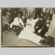 A doctor attending to a man on a stretcher while others look on (ddr-njpa-13-1452)