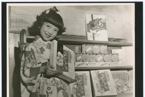 Girl posing with Santa box (ddr-densho-499-25)