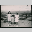 Three Japanese American girls group picture at railroad crossing (ddr-densho-362-41)