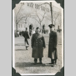 Two men in uniform outside stadium (ddr-ajah-2-513)