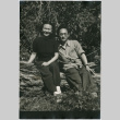 Man and woman sitting on log (ddr-densho-426-1066)
