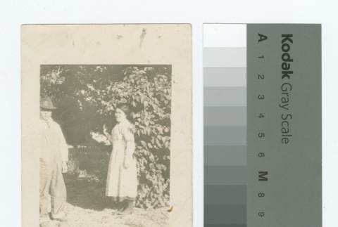 Man and woman standing by trees (ddr-densho-255-63)