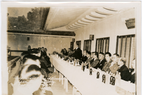 Group of men sitting at banquet table, with man making speech (ddr-densho-426-2092)