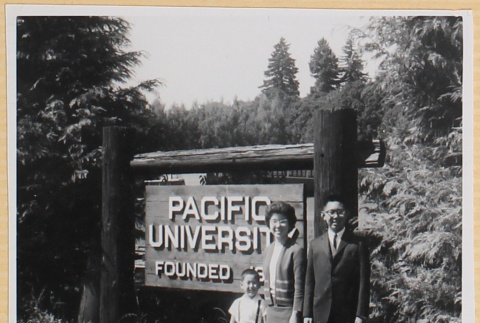 Couple and child standing by sign for Pacific University (ddr-densho-522-66)
