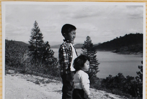 William and Susan Shiomi on hill overlooking water (ddr-densho-522-299)