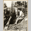 Man seated on a fishing boat (ddr-densho-542-789)