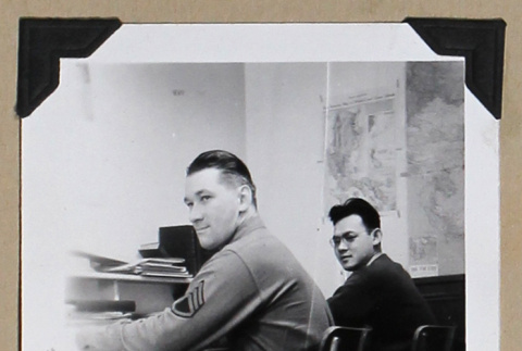 Two men sit at a desk (ddr-densho-404-376)