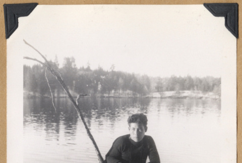 Man poses on a fallen tree (ddr-densho-542-326)