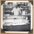 Man standing behind a glass case (ddr-densho-542-106)