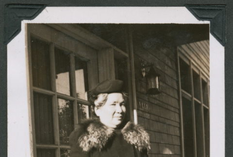 Photo of a woman in an overcoat with a handbag (ddr-densho-483-393)
