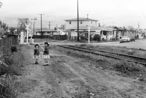 Two girls on dirt path by railroad (ddr-ajah-6-902)