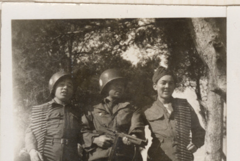 Three men carrying ammunition belts and rifle (ddr-densho-466-308)