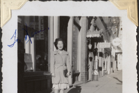 Woman standing on sidewalk outside store (ddr-densho-466-885)